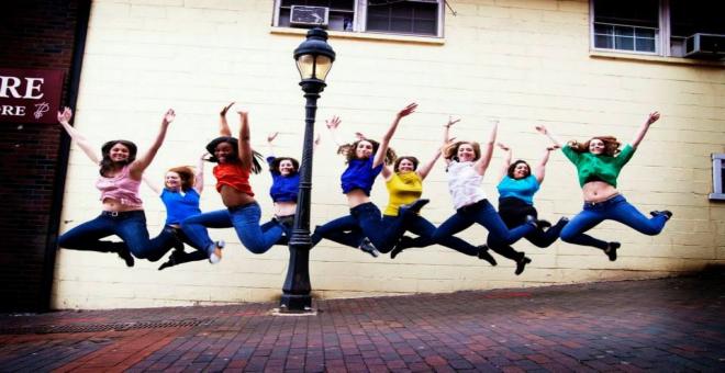 Dancers jumping on the sidewalk