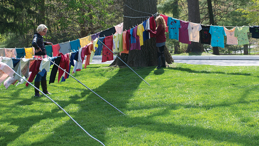 Clothesline with color t-shirts hanging outside with messages on them