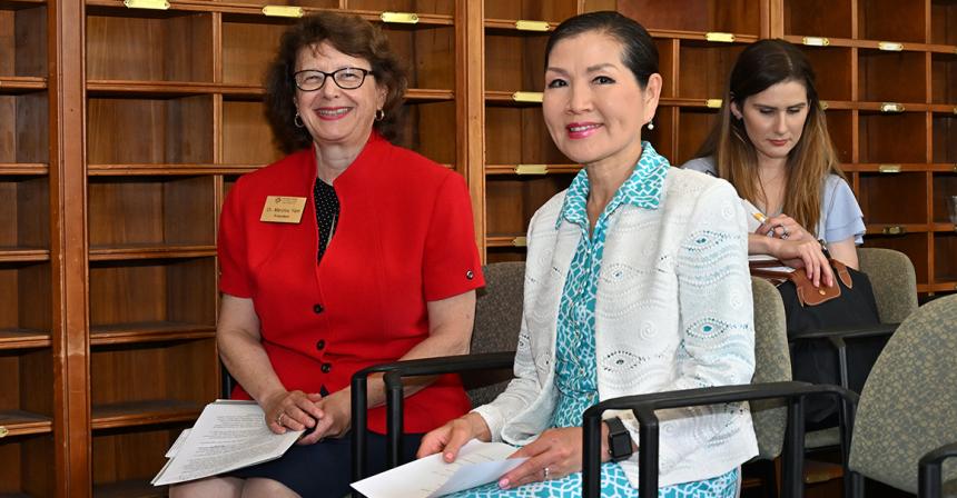 Marylou Yam and Yumi Hogan sit next to each other