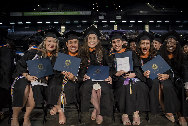 Smiling graduates at commencement 