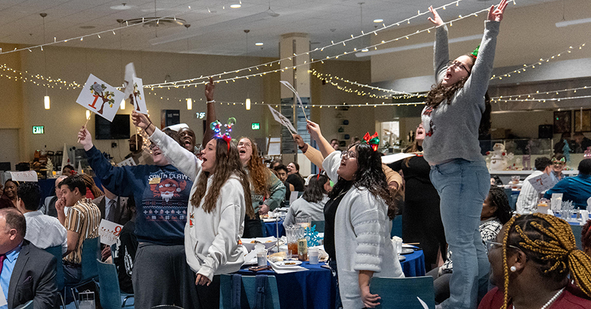 Students singing during Christmas dinner