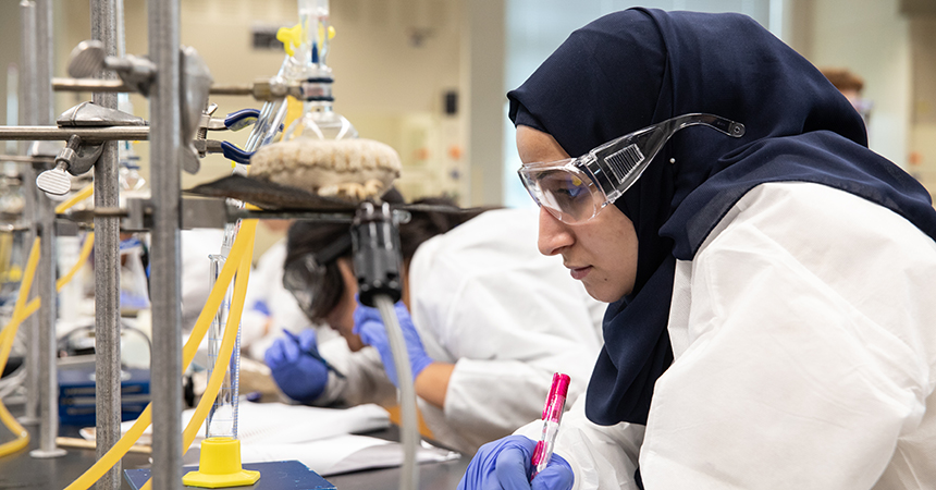 An NDMU student works in a lab on campus