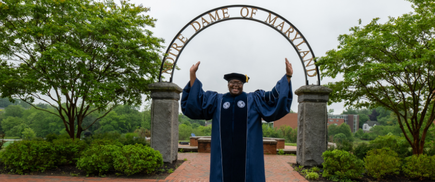Lavorette Preston posing in front of NDMU's archway