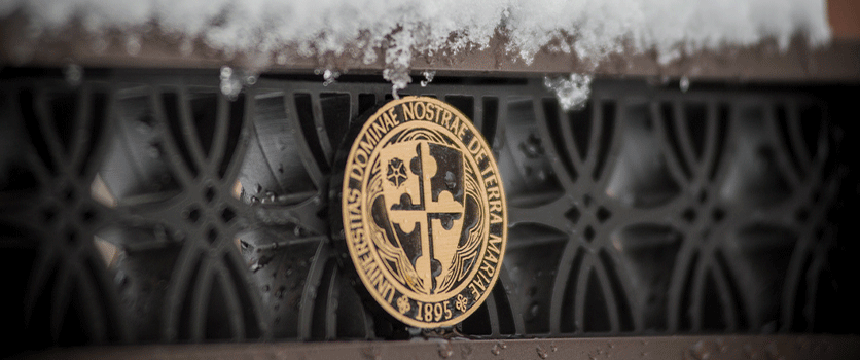 An image of the University seal in the snow