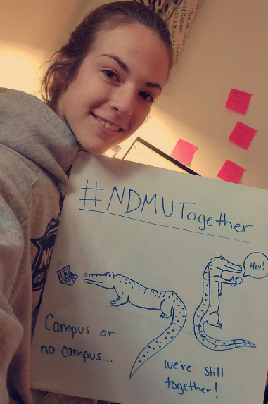 Student Maia Gafies selfie with picture saying #NDMUTogether