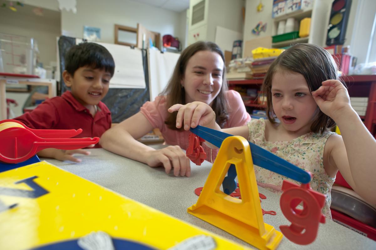Teacher playing with preschoolers