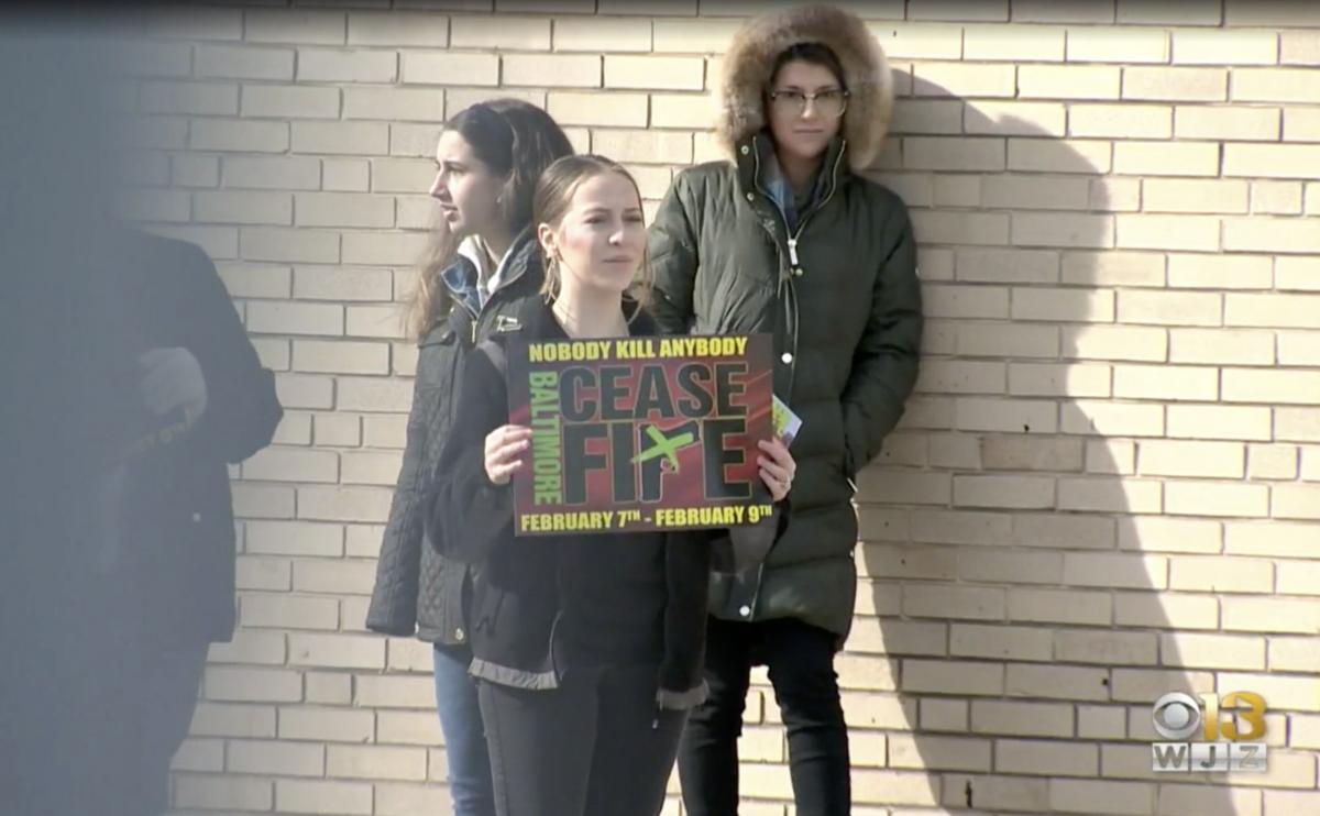 student holding a sign demonstrating at Ceasefire in Baltimore
