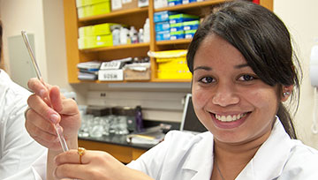Female student in the pharmacy lab holding a test tube