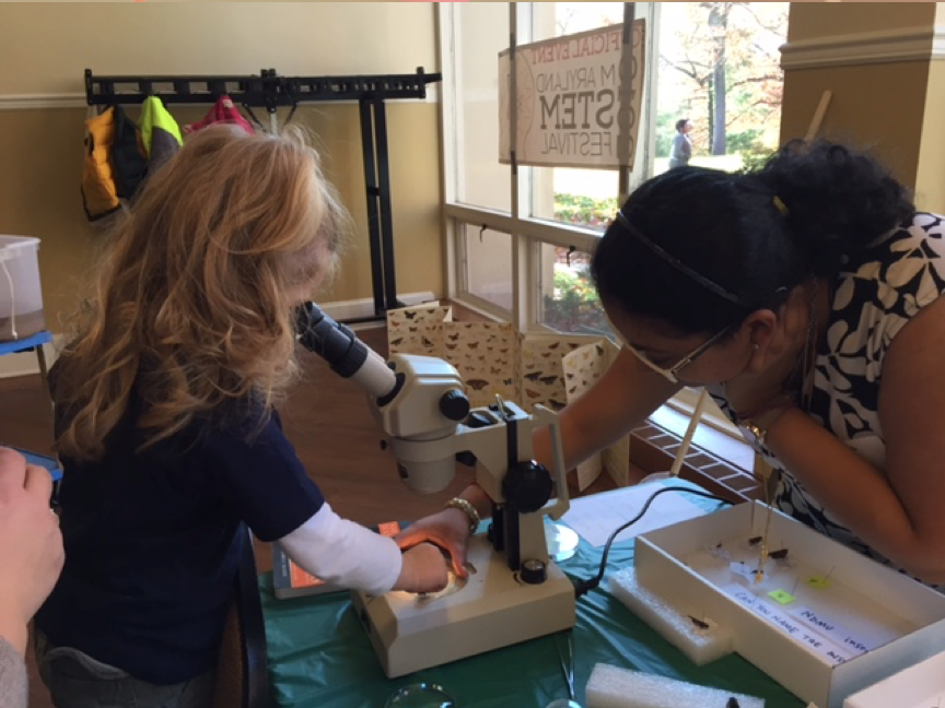 Little girl looking in a microscope