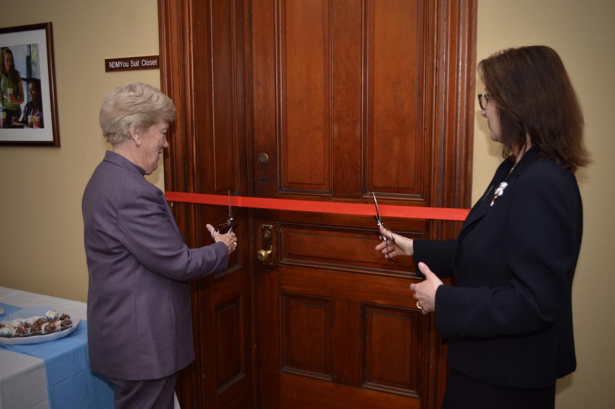 Sr. Sharon and Suzan Harkness cut ribbon in front of NDMYou Suit Closet