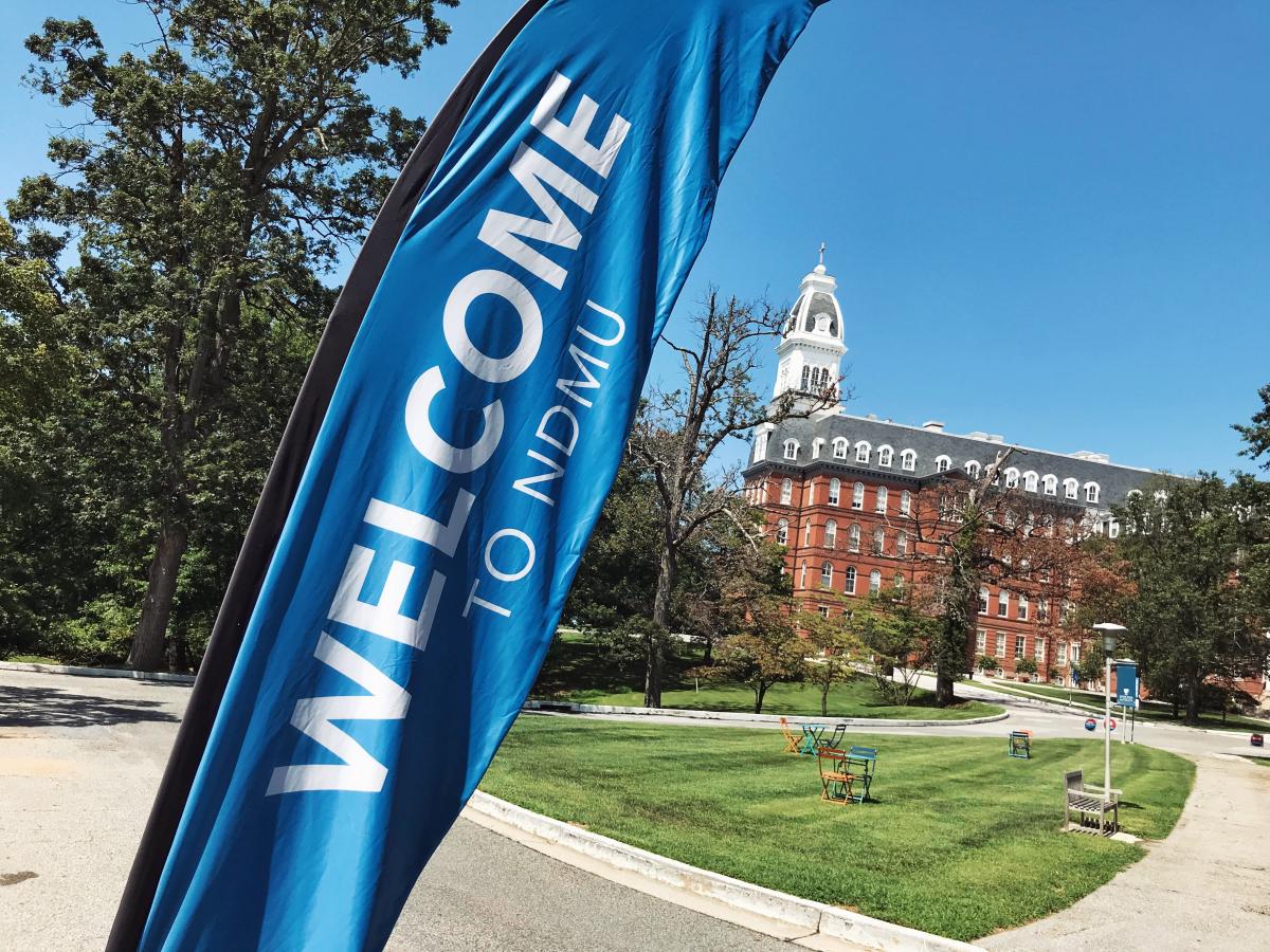 NDMU campus with welcome banner flying on Doyle lawn