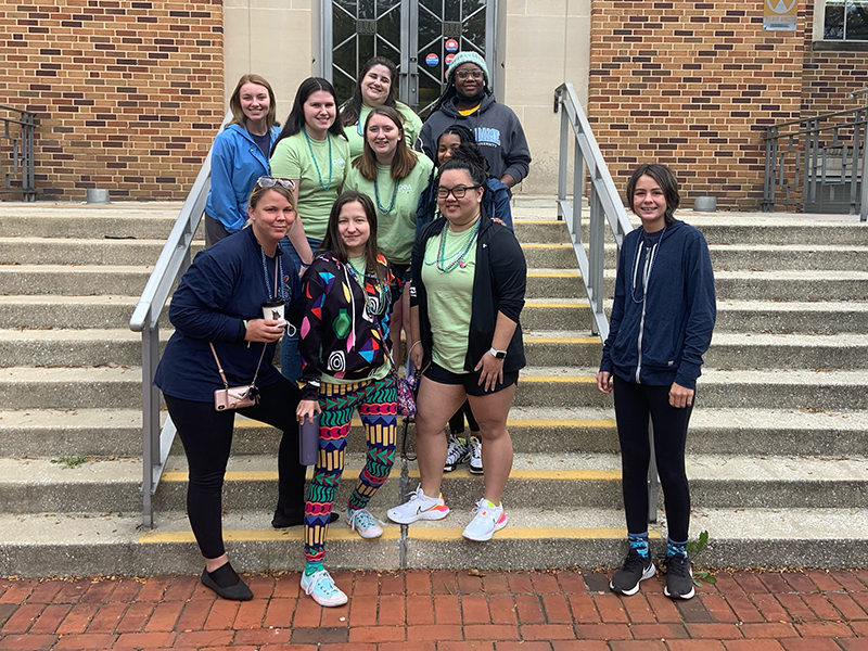 OPhiA members pose on steps during Mental Health Awareness week