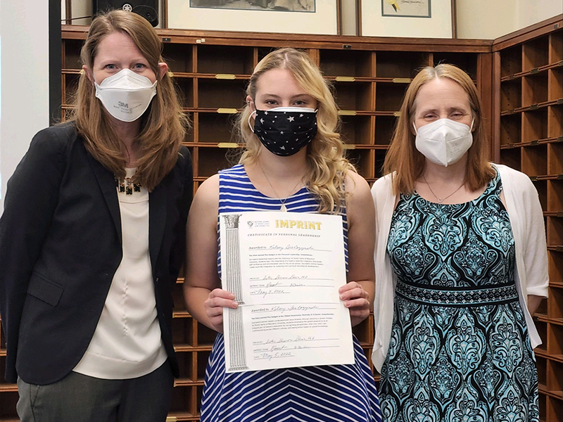 Kelsey Bialozynski receives one of her IMPRINT certificates.