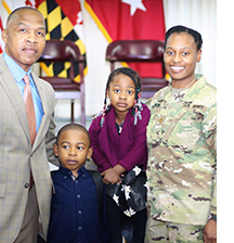 Candice Thompson stands on the right with her husband on the left and their young son and daughter