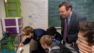 Ryan Hellem M'13 with students at his current school (photo by Kevin Parks/Catholic Review)