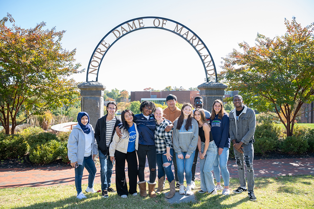 students in front of arch