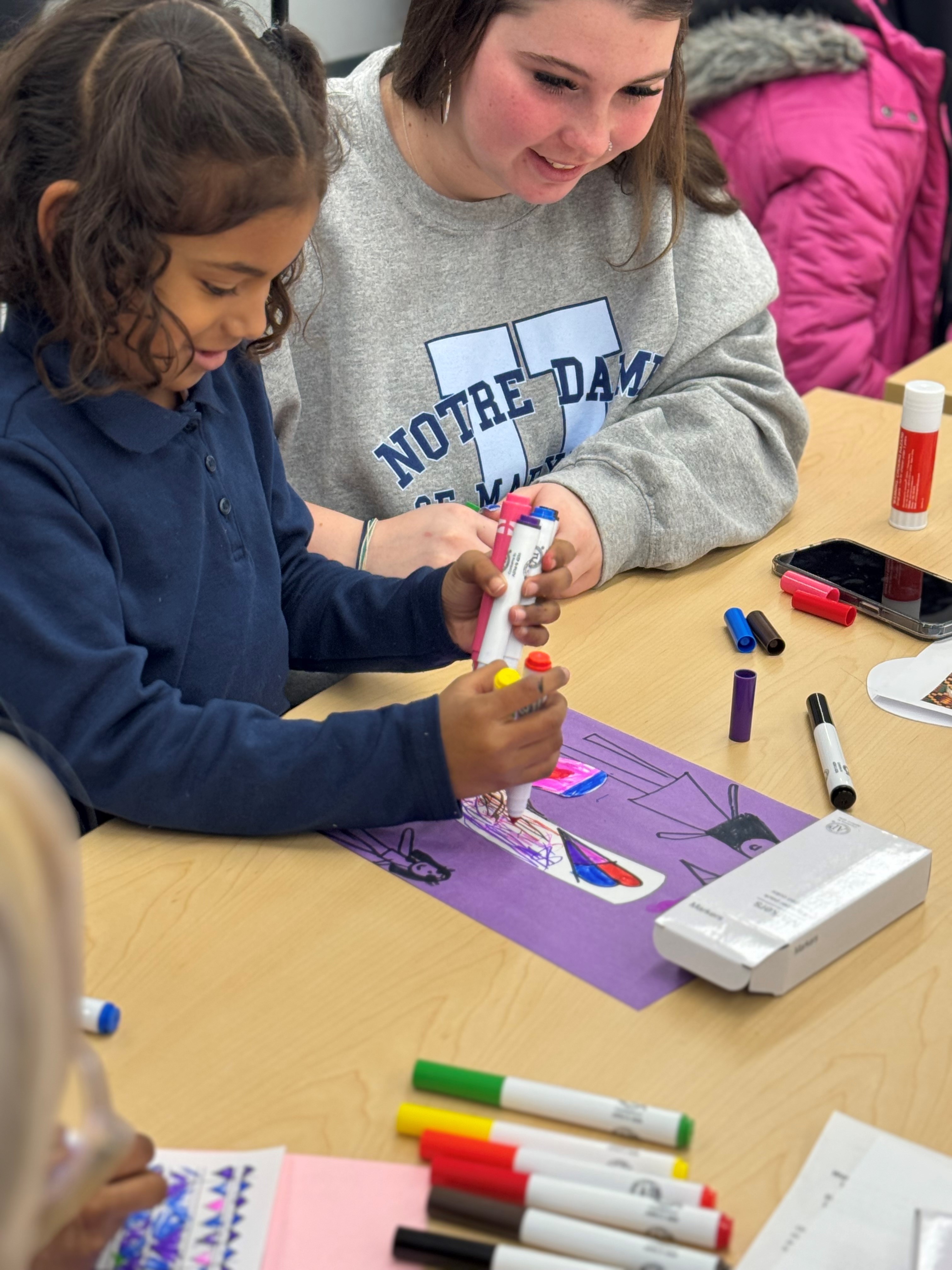 Freshman students participate in a Kindergarten Art program at Govans Elementary School