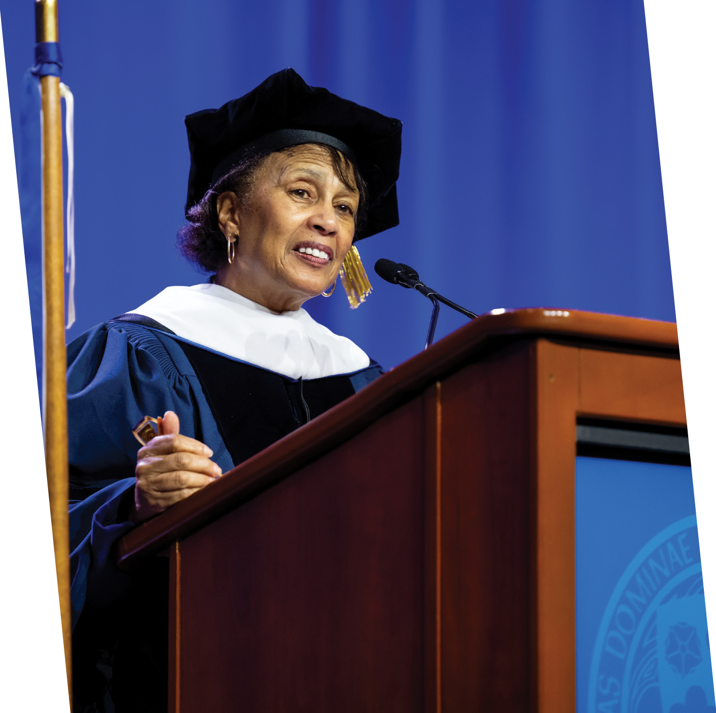 Beverly Malone speaking while wearing regalia