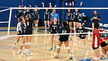 NDMU volleyball members celebrate on court