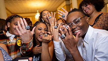 Women's basketball student-athletes with their championship rings