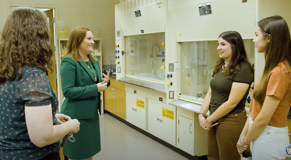 Kelly Barth speaks with students in a lab
