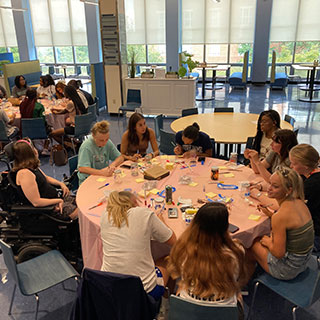 people sitting around round dinner table