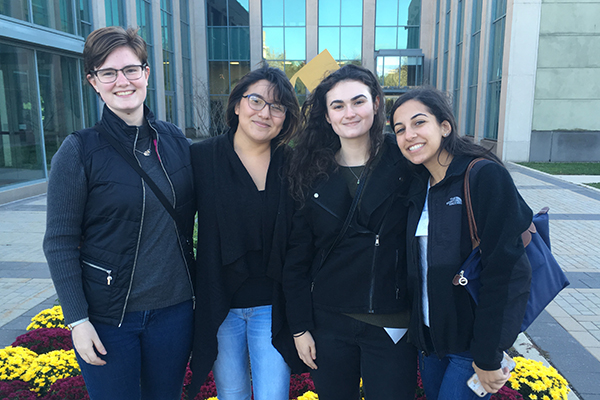 Four NDMU students, including Marion Smedberg and Lesly Mendoza, in a posed picture on campus