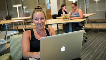 Woman with a lap top in the study lounge