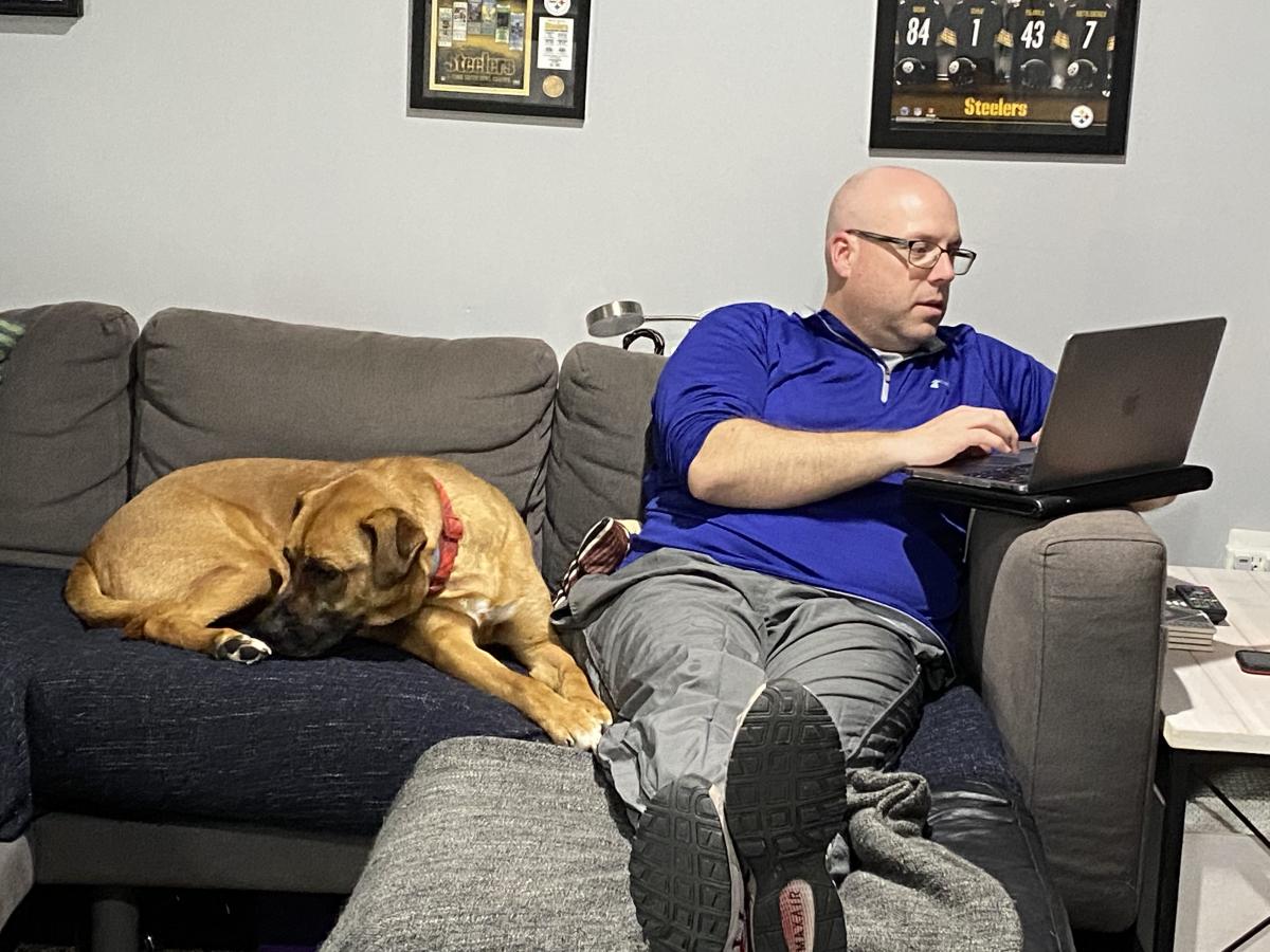 Professor Ryan Schaaf works from home with dog