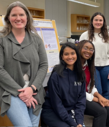 Jennifer Kerr and her students stand in front of a research poster