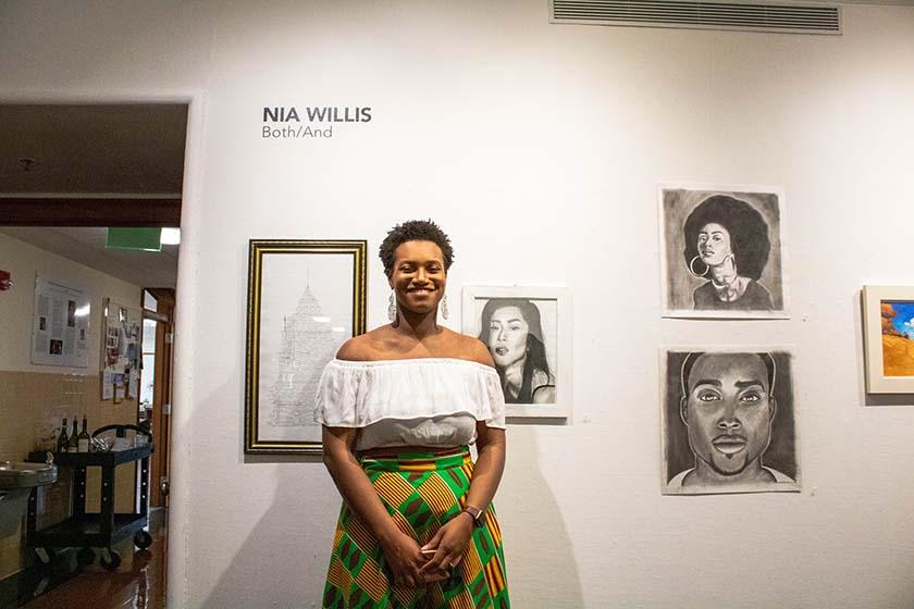 Art student standing in front of her artwork