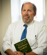 Bill Davis holding a book