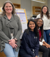 Jennifer Kerr and her students stand in front of a research poster