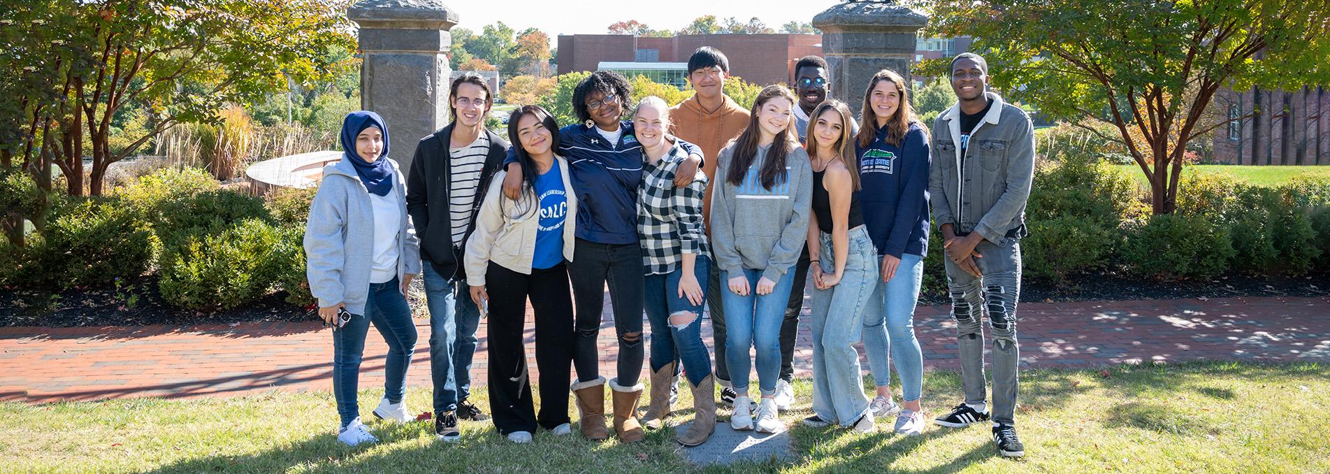 a group of students near NDMU arch