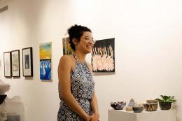 Art student standing in front of her pottery work