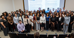 President Yam stands with a large group of students