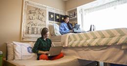 students sitting in dorm room