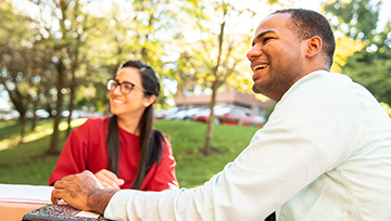 female and male professional students outside on campus