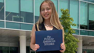 Jolisse Gray outside holding award folder from the presidential program