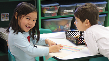 Little girl and boy coloring a picture