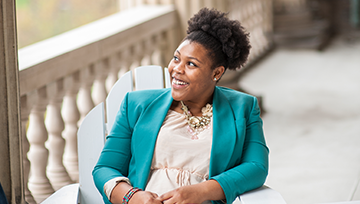 a women in green jacket smiling