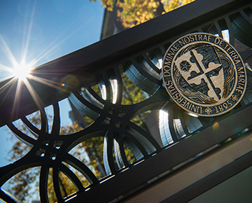 Close up of notre dame seal with sun flare