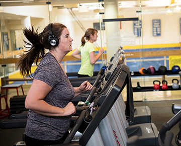 Students running on the treadmill in the fitness center