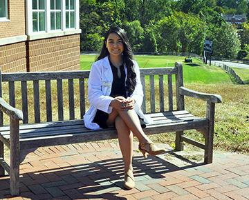 Rose Sebastian sitting on a bench outside