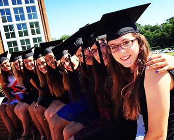 Row of students wearing graduation caps