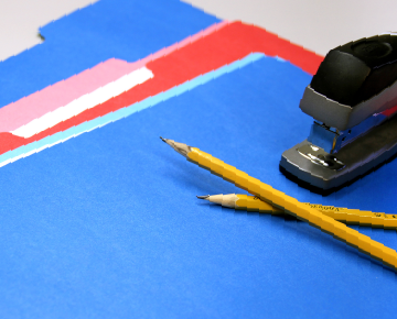 Colorful folders, pencils, and a stapler