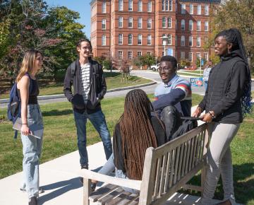 5 students gathering outside