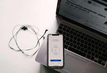 Photo by Allie on Unsplash iphone and computer preparing for a meeting