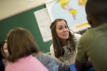 Teacher speaks with a group of students