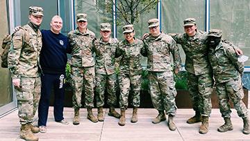 Ricelle Taganas, NDMU student, poses with her Army Reserves team in fatigues in NYC